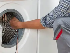 Dryer repair technician diagnosing and servicing a clothes dryer in Rockford, IL