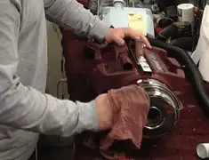 Vacuum repair technician cleaning and servicing a vacuum motor in Rockford, IL